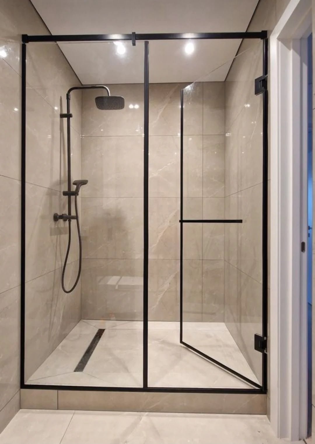 Elegant glass shower partition separating bathroom areas